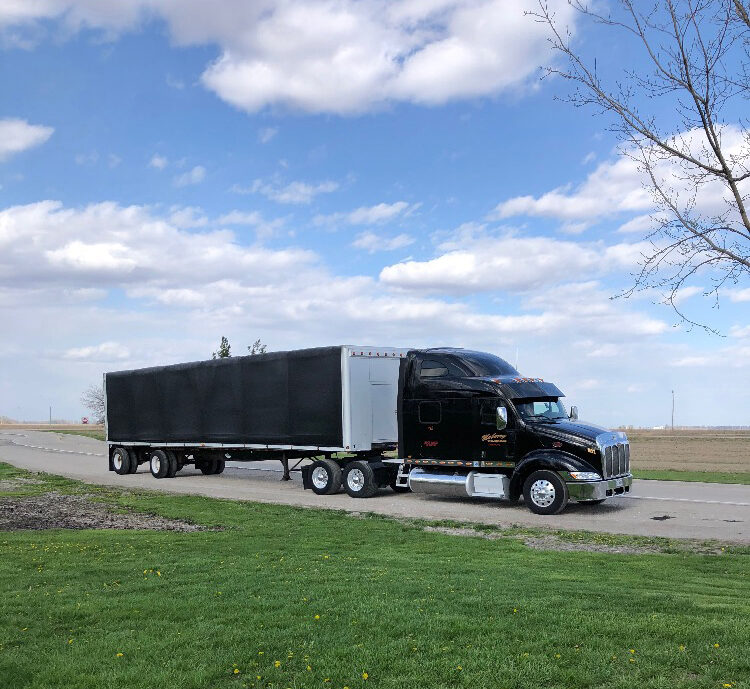 Maberry Trucking 211 parked along grass