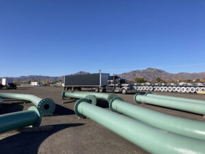 Maberry Trucking Truck in yard with pipes laying on ground