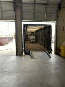 Truck at loading dock with forklift